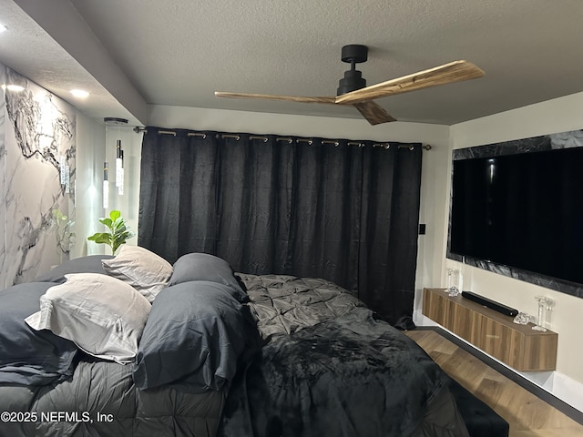 bedroom featuring a textured ceiling and wood finished floors