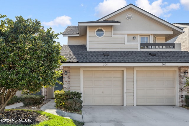 multi unit property with a balcony and a garage