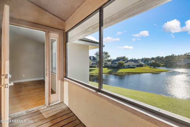 304 Tournament Rd, Ponte Vedra Beach, FL 32082 - unfurnished sunroom featuring a water view, wood finished floors, and vaulted ceiling