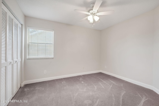 unfurnished bedroom featuring ceiling fan, a closet, and carpet floors