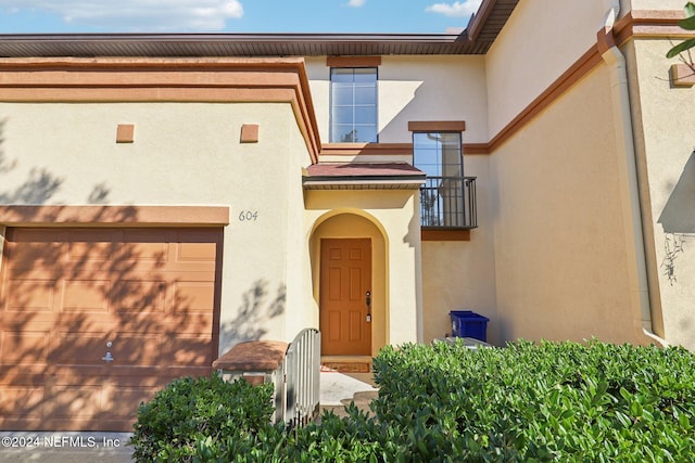 doorway to property with a garage