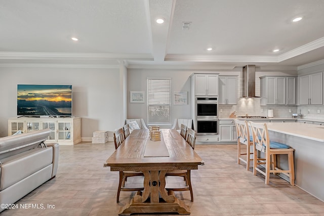 dining area with light hardwood / wood-style floors and crown molding