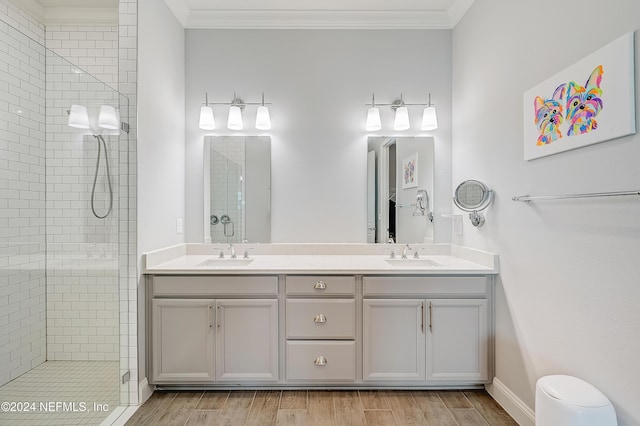 bathroom with vanity, an enclosed shower, and ornamental molding