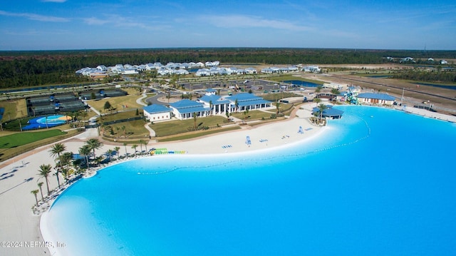 birds eye view of property with a water view and a view of the beach