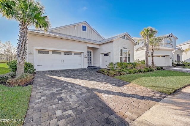 view of front of home featuring a garage and a front lawn