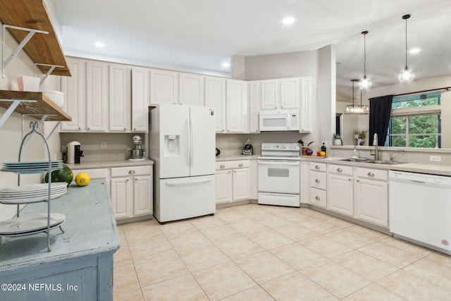 kitchen featuring white appliances, white cabinetry, hanging light fixtures, and sink