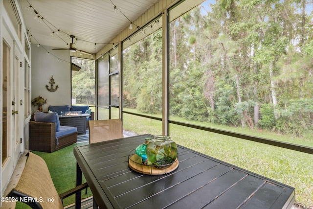 unfurnished sunroom featuring ceiling fan