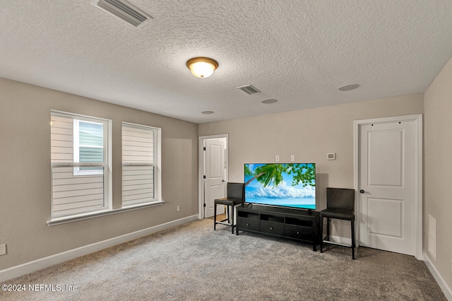 living room featuring carpet and a textured ceiling