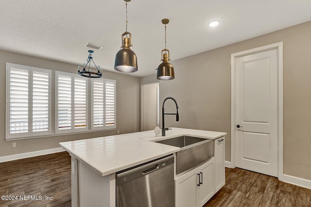 kitchen with dishwasher, hanging light fixtures, dark hardwood / wood-style floors, an island with sink, and white cabinets