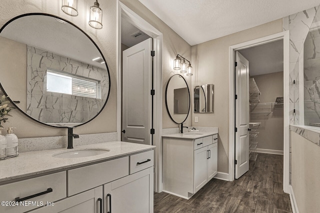 bathroom featuring vanity, a textured ceiling, and hardwood / wood-style flooring