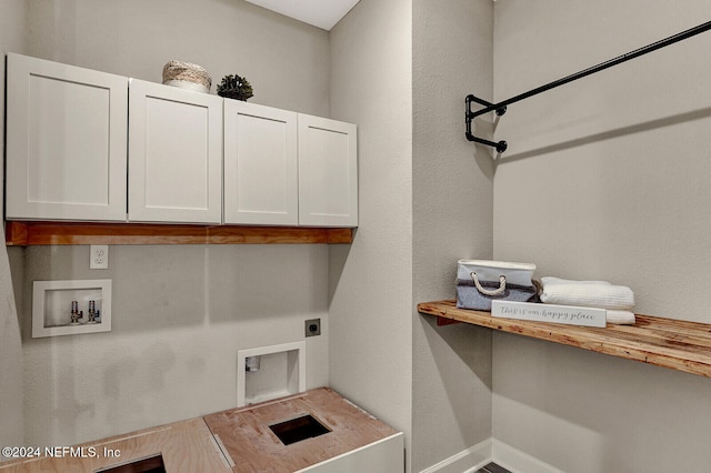 laundry area featuring electric dryer hookup, cabinets, and hookup for a washing machine