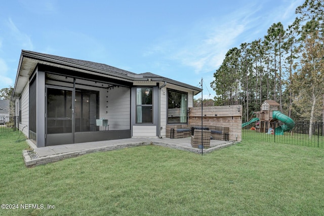 back of property with a yard, a playground, and a patio