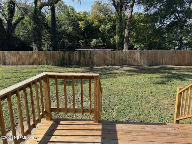 wooden deck with a lawn