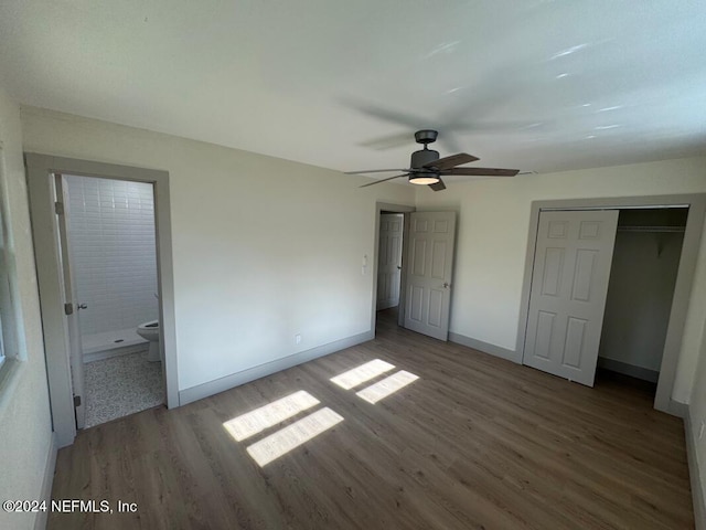 unfurnished bedroom featuring a closet, ceiling fan, hardwood / wood-style floors, and ensuite bathroom