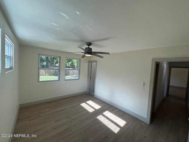 empty room featuring ceiling fan and dark wood-type flooring