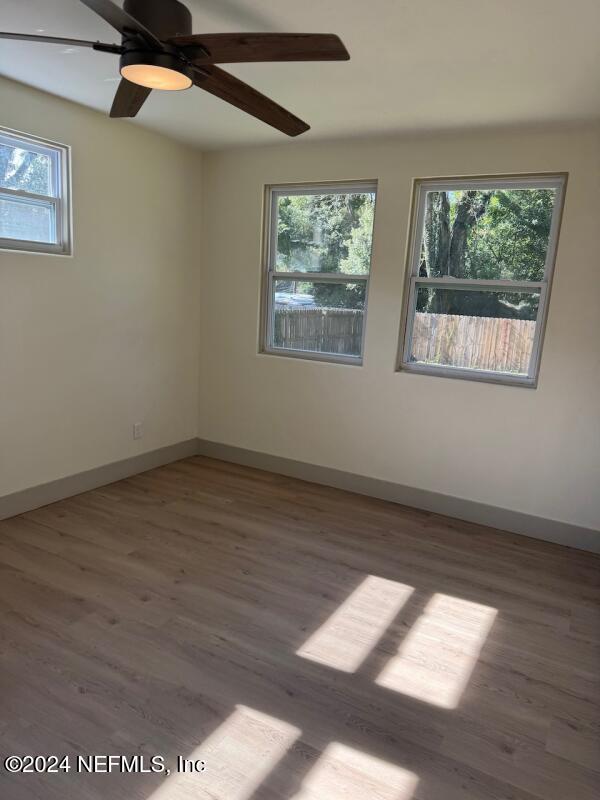 spare room featuring hardwood / wood-style flooring and ceiling fan