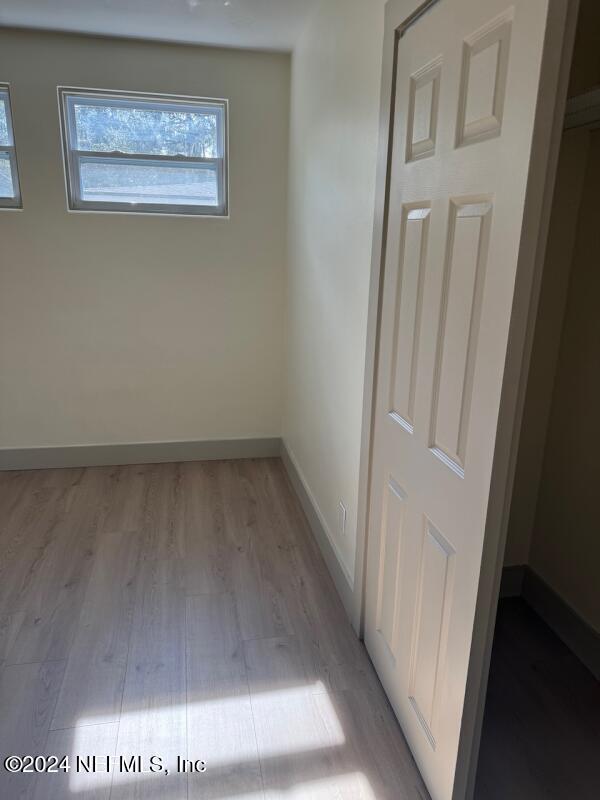 spare room with light wood-type flooring