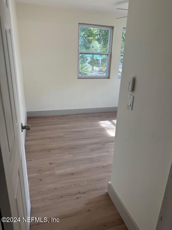 unfurnished room with light wood-type flooring