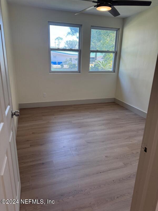 empty room featuring light wood-type flooring and ceiling fan