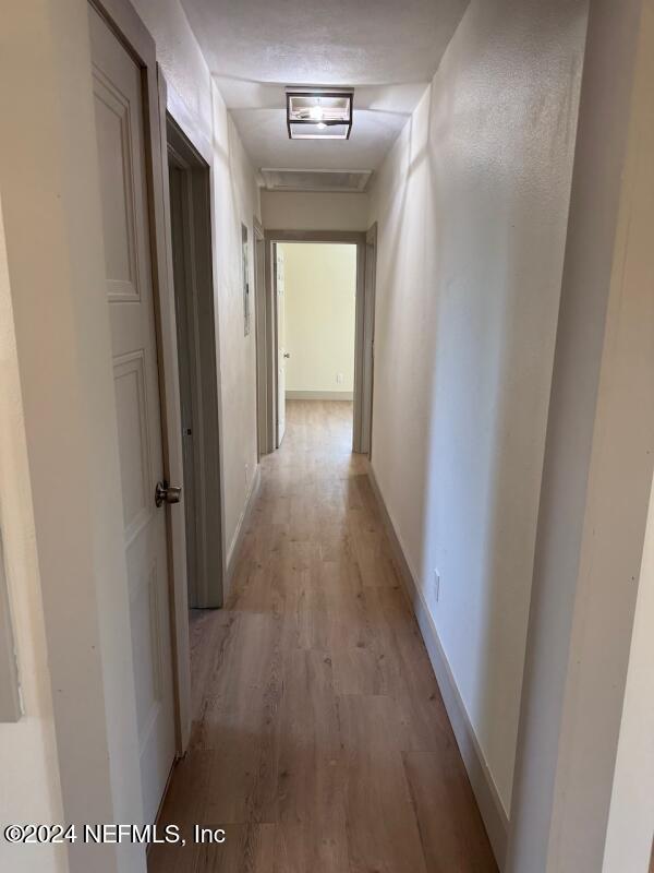 corridor with light wood-type flooring