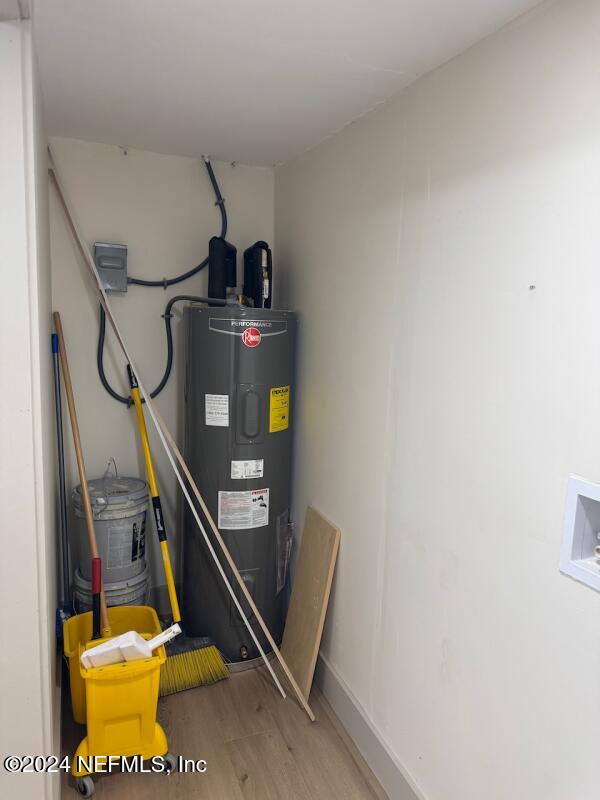 utility room featuring electric water heater