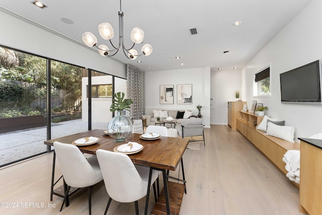 dining area featuring a notable chandelier and light wood-type flooring