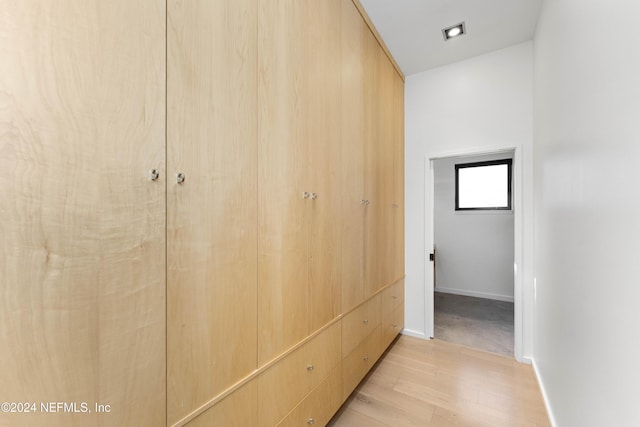 hallway with light hardwood / wood-style flooring