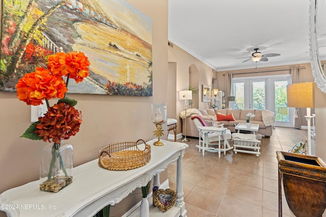 living room with ceiling fan, light tile patterned floors, and ornamental molding