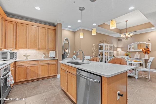 kitchen with sink, stainless steel appliances, an island with sink, pendant lighting, and a chandelier