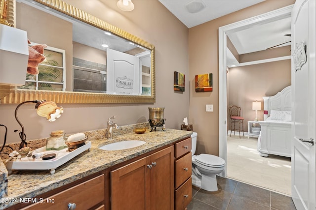 bathroom featuring walk in shower, tile patterned flooring, vanity, and toilet