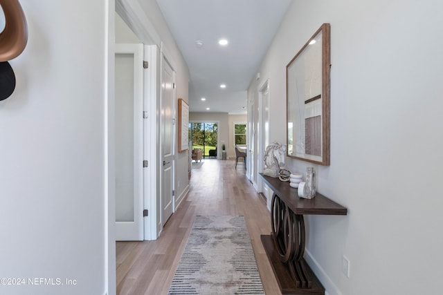 corridor with light hardwood / wood-style flooring