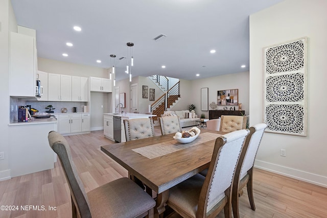 dining room featuring light hardwood / wood-style flooring and sink