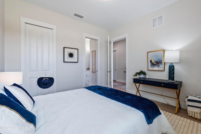 bedroom featuring light hardwood / wood-style flooring and a closet