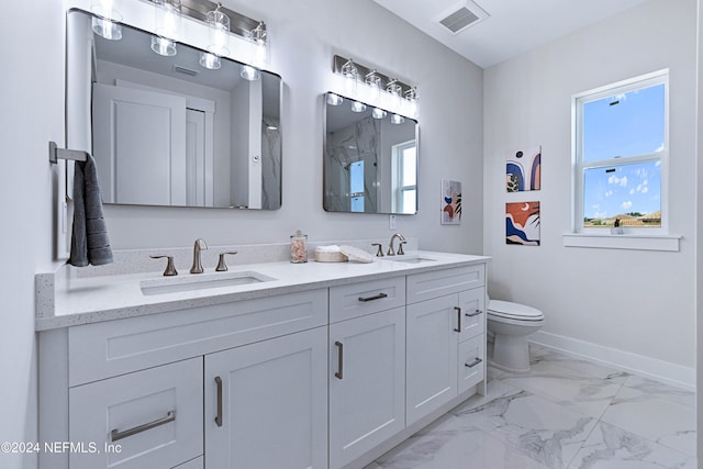 bathroom with vanity and toilet