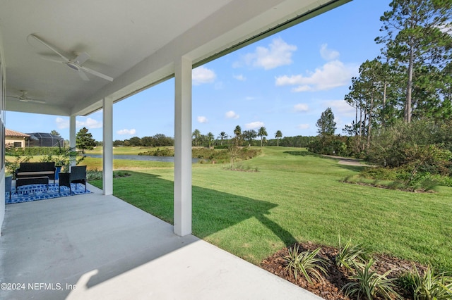 view of yard featuring ceiling fan and a patio