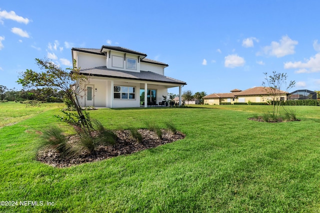 back of house featuring a yard