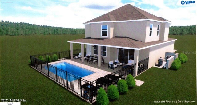 rear view of house with a fenced in pool, a patio area, and a yard