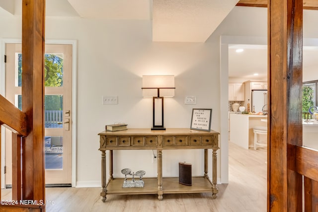 hallway featuring light hardwood / wood-style flooring and plenty of natural light