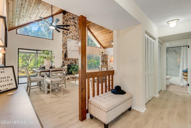 hall featuring high vaulted ceiling, wood ceiling, and light hardwood / wood-style flooring