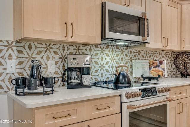 kitchen with decorative backsplash, high end white range, and light brown cabinetry