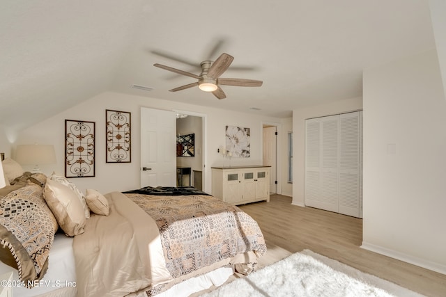 bedroom featuring ceiling fan, a closet, vaulted ceiling, and light hardwood / wood-style floors