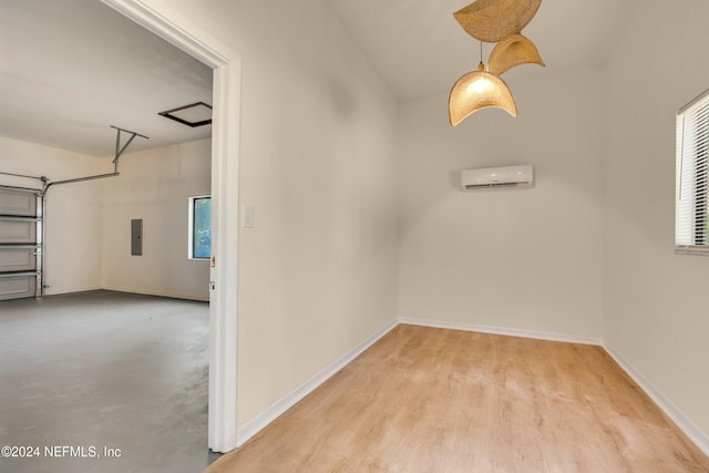 interior space with electric panel and a wall mounted air conditioner