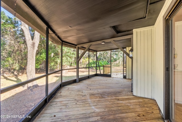 unfurnished sunroom featuring wood ceiling and plenty of natural light