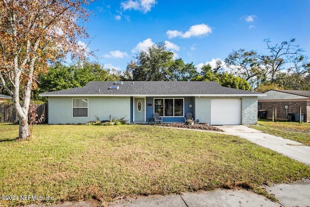 single story home with a garage and a front lawn