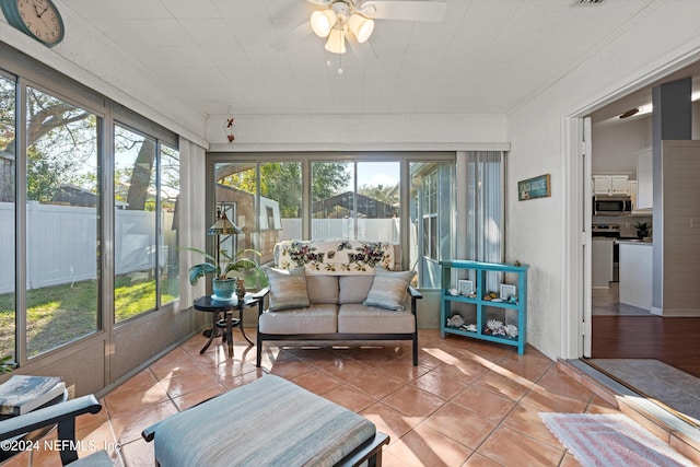 sunroom / solarium featuring ceiling fan