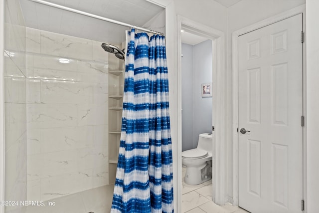 bathroom featuring toilet and walk in shower