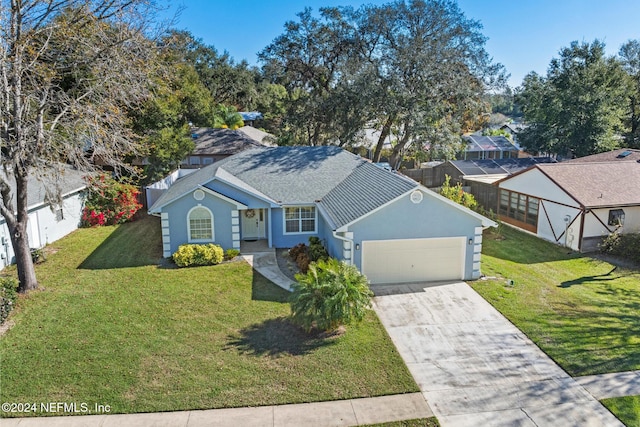 view of front facade featuring a front lawn and a garage