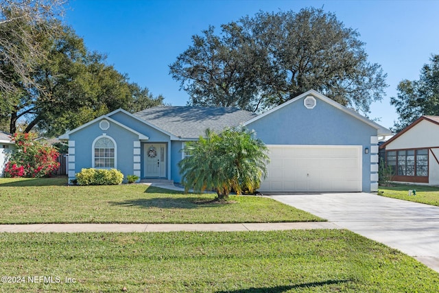 ranch-style house with a garage and a front lawn