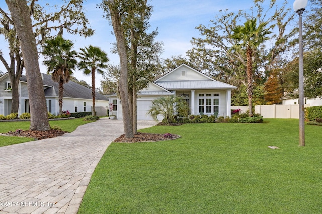 view of front facade featuring a garage and a front lawn