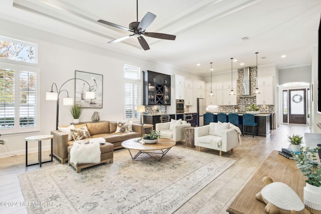 living room featuring ceiling fan, light hardwood / wood-style flooring, and ornamental molding